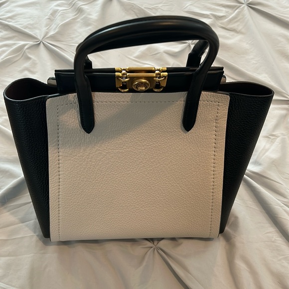 Coach satchel bag in black and beige. Never been used comes with shoulder strap.